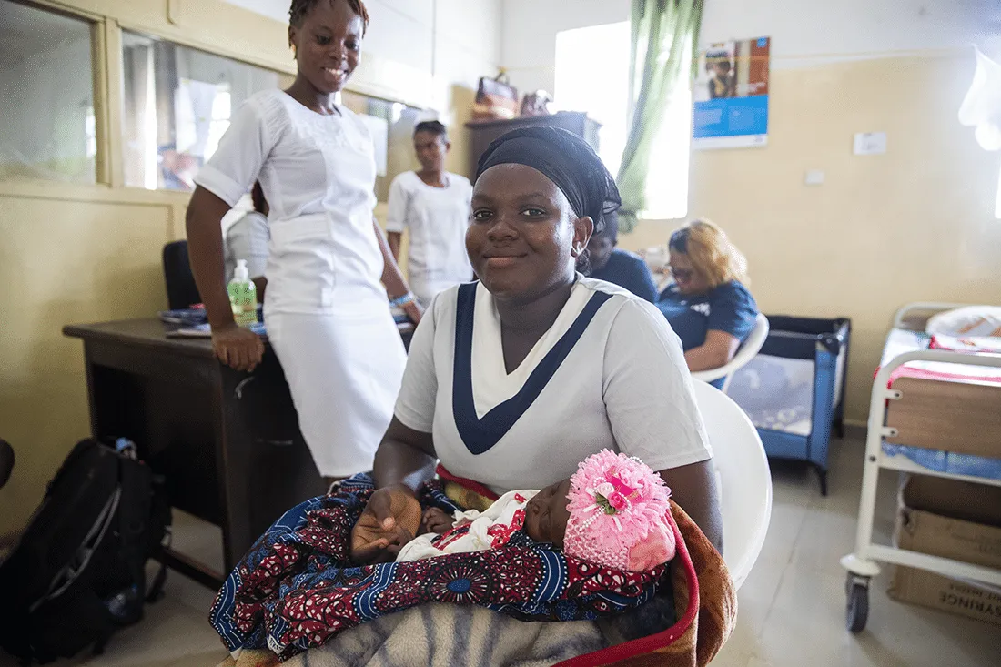 Woman holding newborn baby